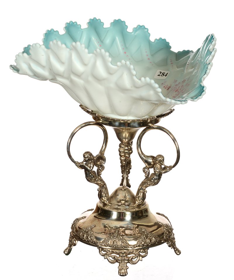 13 1/4" X 12" BRIDES BASKET: 13 1/4" X 12" BRIDES BASKET BLUE CASED ART GLASS TRI-CORNER BOWL WITH LATTICE MOLD AND ENAMEL FLORAL HIGHLIGHTS - SET ON ROGERS SILVERPLATE STAND FEATURING CHERUBS BLOWING HORNS