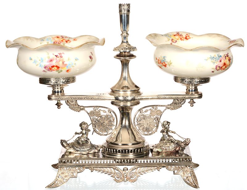 15 1/4" X 20" DOUBLE BRIDES BASKET: 15 1/4" X 20" DOUBLE BRIDES BASKET PAIR MT. WASHINGTON COLONIAL WARE BOWLS WITH ENAMEL SCATTERED FLORAL DECOR - SET ON MARKED PAIRPOINT SILVERPLATE STAND WITH TWO CHERUBS RIDING TURTLES - CENTER BUD V