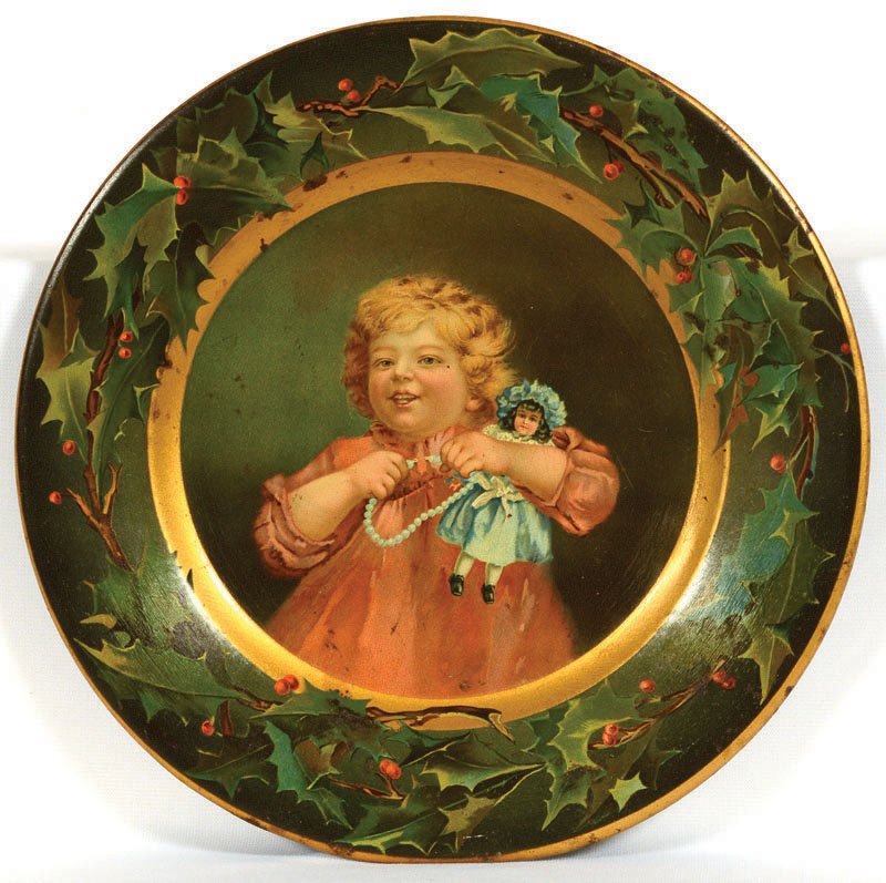 10" TIN ADVERTISING PLATE: 10" TIN ADVERTISING PLATE YOUNG GIRL HOLDING DOLL AND NECKLACE - CHRISTMAS WREATH BORDER - "COMPLIMENTS OF C.D. KENNY CO." - NORMAL EXPECTED WEAR