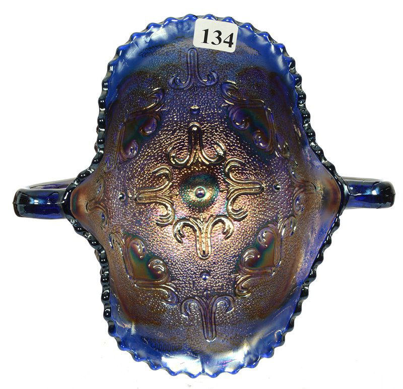 CARNIVAL GLASS TWO HANDLED PEDESTAL BON-BON: CARNIVAL GLASS TWO HANDLED PEDESTAL BON-BON PUZZLE PATTERN INTERIOR BY DUGAN - RARE BANANA DISH SHAPE IN BLUE