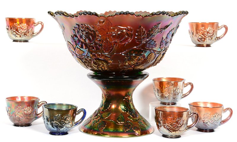 CARNIVAL GLASS 10" X 12" WREATH OF ROSES PATTERN PUNCH: CARNIVAL GLASS 10" X 12" WREATH OF ROSES PATTERN PUNCH SET BY FENTON AMETHYST - TWO PART BOWL HAS VINTAGE INTERIOR - (6) CUPS (ONE IS BLUE) - BOTTOM OF PUNCH BOWL HAS CHIP - (2) CUPS HAVE CHIPS
