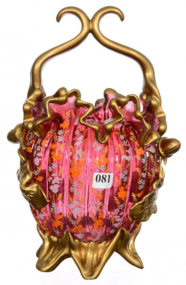 11" CRANBERRY ART GLASS BASKET: 11" CRANBERRY ART GLASS BASKET MELON RIBBED BODY WITH ENAMELED FLORAL HIGHLIGHTS - RE-GILDED HANDLE AND APPLIED ACORN LEAF AND FEET - CRANBERRY BODY IS CRACKED
