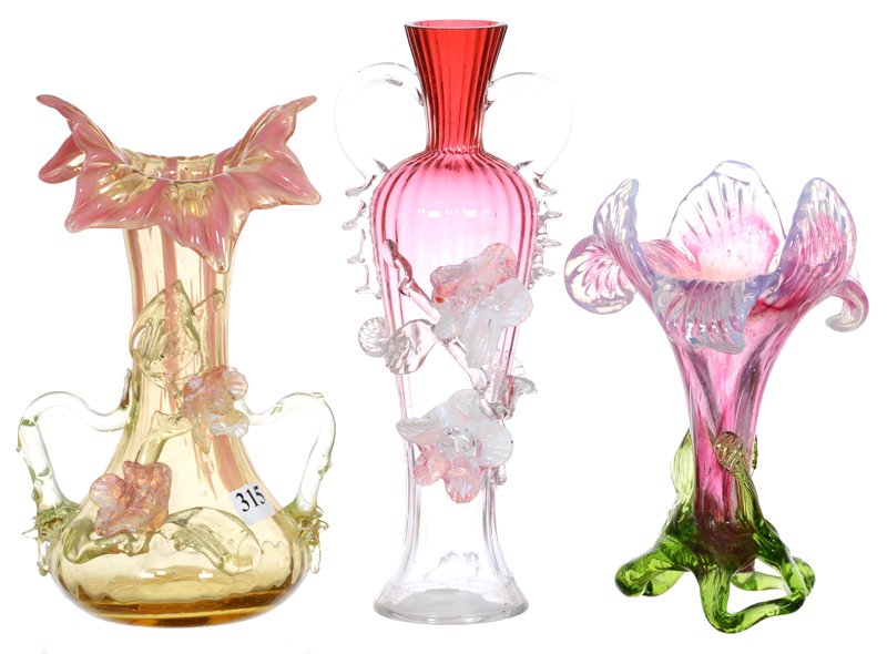 (3) STEVENS & WILLIAMS STYLE ART GLASS VASES: (3) STEVENS & WILLIAMS STYLE ART GLASS VASES (1) 9 1/2" TWO HANDLED RUBINA WITH APPLIED FLORAL - (1) 8 1/2" VASELINE AND PINK WITH APPLIED FLORAL (ONE BLOSSOM WITH SMALL REPAIR) - (1) 7" LAVENDER LILY