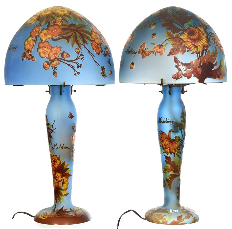 PAIR 23" MODERN REPRODUCTION MARKED MADELAINE CAMEO: PAIR 23" MODERN REPRODUCTION MARKED MADELAINE CAMEO TABLE LAMPS NICE BLUE BACKGROUND - (1) LAMP FEATURES CARNATION AND BUTTERFLY DECOR - (1) LAMP FEATURES FLORAL BLOSSOM AND BUTTERFLY DECOR