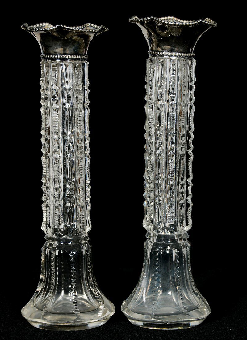 BUD VASES, PAIR, WITH STERLING RIMS - 6 3/4" X 2": BUD VASES, PAIR, WITH STERLING RIMS - 6 3/4" X 2" PRISM CUT BODY - (1) VASE IS MARKED "MAY 6, 1901 A.P.C" ON SILVER - BOTH SILVER RIMS ARE LOOSE
