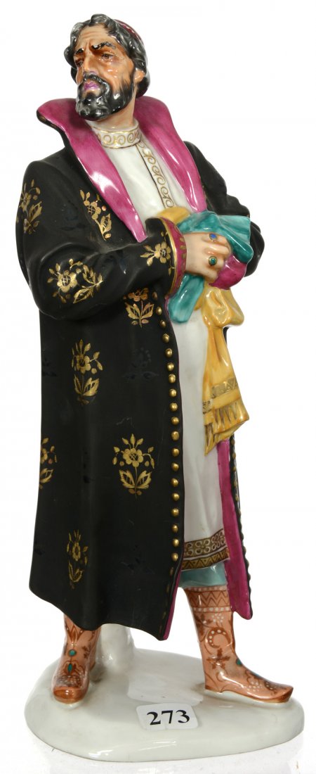 10 3/4" UNMARKED PORCELAIN FIGURE: 10 3/4" UNMARKED PORCELAIN FIGURE FIGURE OF MAN IN BLACK CLOAK WITH GOLD STENCIL HIGHLIGHTS - ATTRIBUTED TO RUSSIAN PORCELAIN FACTORY