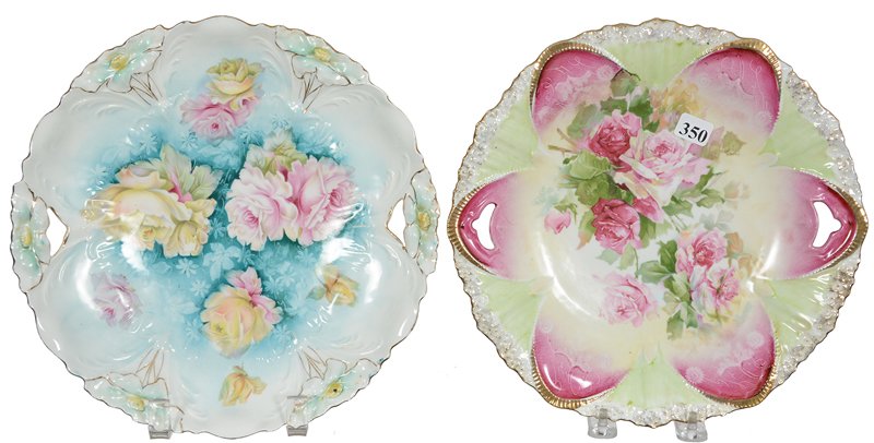 (2) 10 1/4" PRUSSIA TWO-HANDLED CAKE PLATES: (2) 10 1/4" PRUSSIA TWO-HANDLED CAKE PLATES (1) PINK & GREEN TONES WITH PINK ROSE DECOR MARKED RSP - (1) BLUE & WHITE TONES, PINK AND YELLOW DECOR, LILY MOLD, UNMARKED