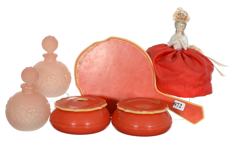 SIX PIECE DRESSER SET: SIX PIECE DRESSER SET (1) 6" X 5" PORCELAIN HEAD PIN CUSHION DOLL, RED DRESS - RED CELLULOID HAND MIRROR WITH MATCHING HAIR RECEIVER AND POWDER BOX - (2) 5" EMBOSSED FLORAL AND LATTICE ROUND COLOGNE B
