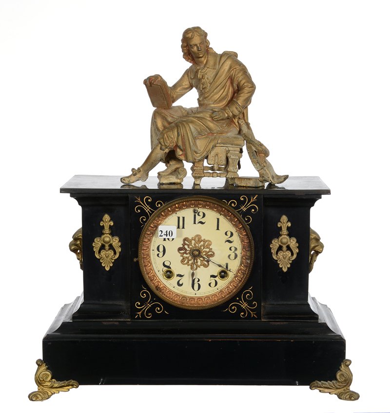 18" X 16" MANTEL IRON CLOCK - EBONY CASE WITH GILT: 18" X 16" MANTEL IRON CLOCK - EBONY CASE WITH GILT HIGHLIGHTS TOPPED BY FIGURE OF SCHOLAR SEATED IN CHAIR - ANSONIA WORKS