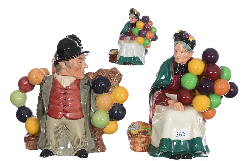(3) Royal Doulton Figurines - (1) 7 1/2" Titled "The: (3) Royal Doulton Figurines - (1) 7 1/2" Titled "The Old Balloon Seller" HN#1315 - (1) 3 1/2" Titled "The Old Balloon Seller" HN #2129 - (1) 7" Double-Sided Teapot Featuring Balloon Man And Balloon Wo