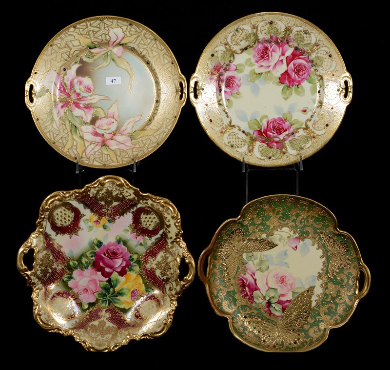 (4) NIPPON TWO HANDLED CAKE PLATES: (4) NIPPON TWO HANDLED CAKE PLATES INCLUDING(2) 10.5", ONE WITH ORCHIDS, OTHER WITH ROSES - (1) 11" SQUARE, ROSE DECOR & RED TRIM HIGHLIGHTS - (1) GREEN BORDER WITH BUTTERFLY DECOR, SERIOUS HANDLE REP