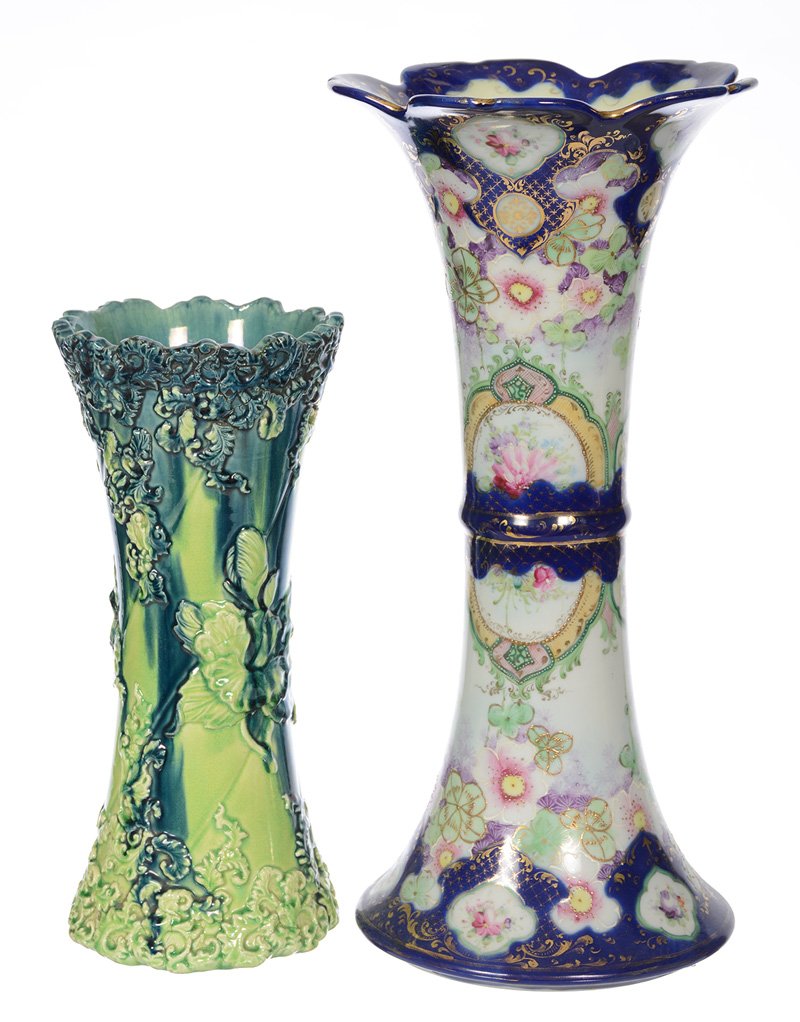 (2) CORSET SHAPED VASES: (2) CORSET SHAPED VASES - (1) 16.5" UNMARKED NIPPON, WHITE AND COBALT BLUE WITH COLORFUL FLORAL DECOR (CROW'S FOOT) - (1) 12" UNMARKED MAJOLICA, GREEN TONES WITH EMBOSSED FLORAL DESIGN