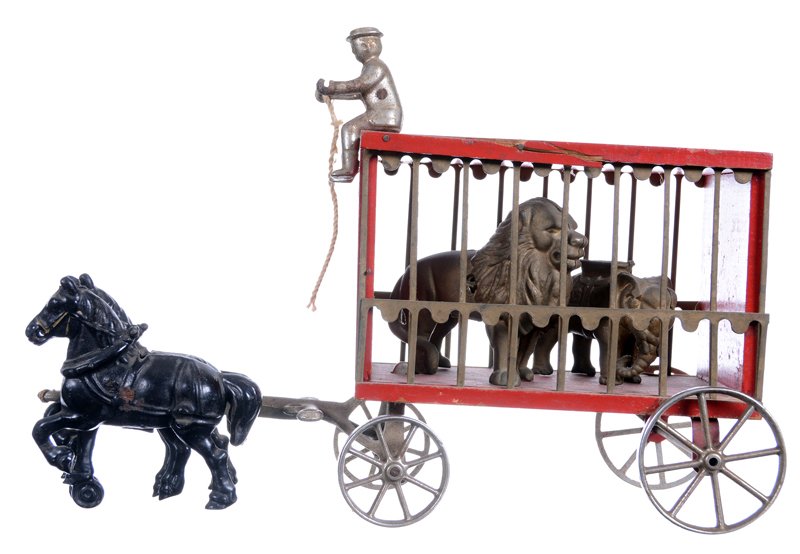 9.5" X 14" CAST IRON AND WOOD VINTAGE ARCADE TOY: 9.5" X 14" CAST IRON AND WOOD VINTAGE ARCADE TOY CIRCUS DRIVER - ORIGINAL ANIMAL MISSING - REPLACED WITH CAST IRON LION BANK AND CAST IRON ELEPHANT BANK - ONE WOODEN TRIM PIECE HAS A SPLIT