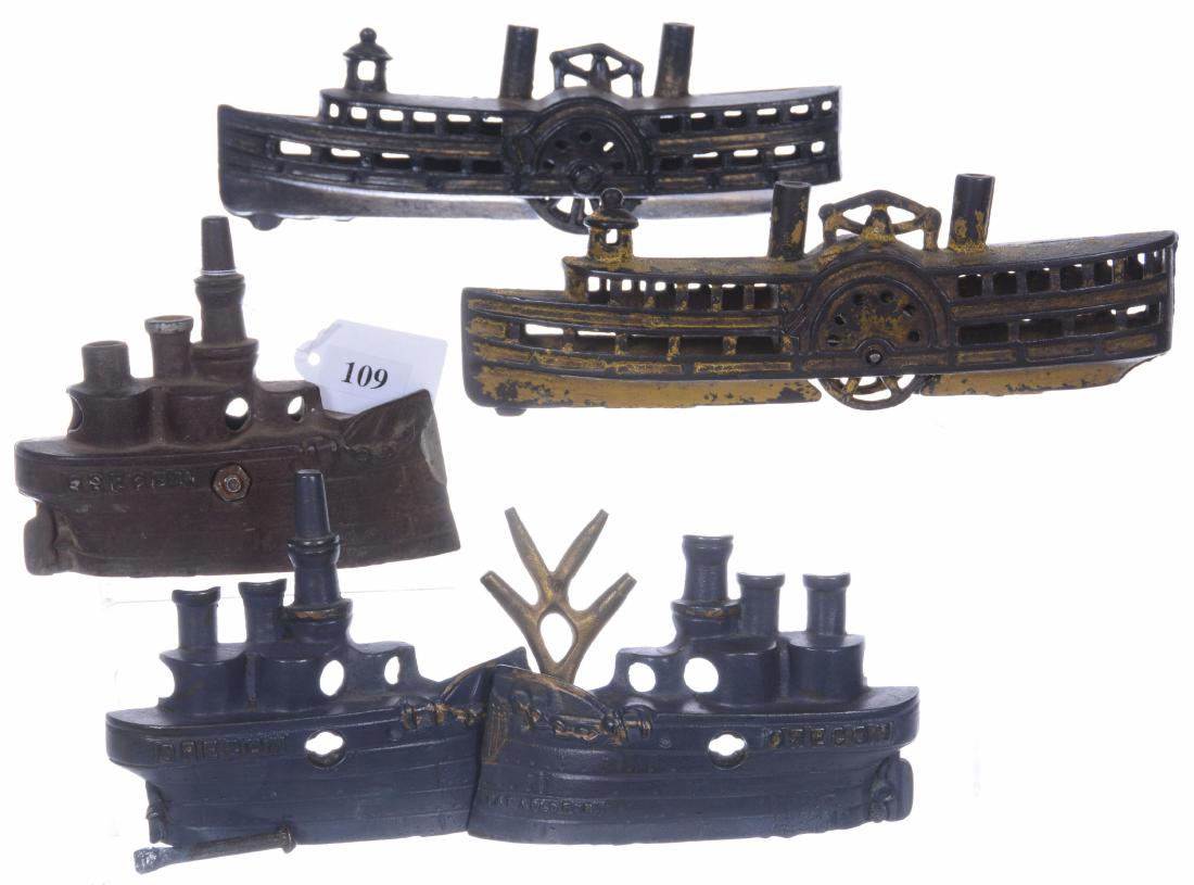 (4) CAST IRON FIGURAL BOAT BANKS INCLUDING: (2) 4" X 5" OREGON BATTLESHIPS, ONE IS MISSING GUN, ONE IS NOT ASSEMBLED - (2) 2.5" X 8" STEAM PADDLE WHEELER