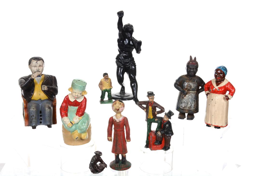 (9) ASSORTED CAST IRON AND METAL FIGURES: (1) TAMMANY BANK- ARM IS LOOSE - (1) MUTT AND JEFF BANK - (2) BLACK MEMORABILIA MAMMY BANKS - (1) OLIVE OIL BANK - AND MORE 