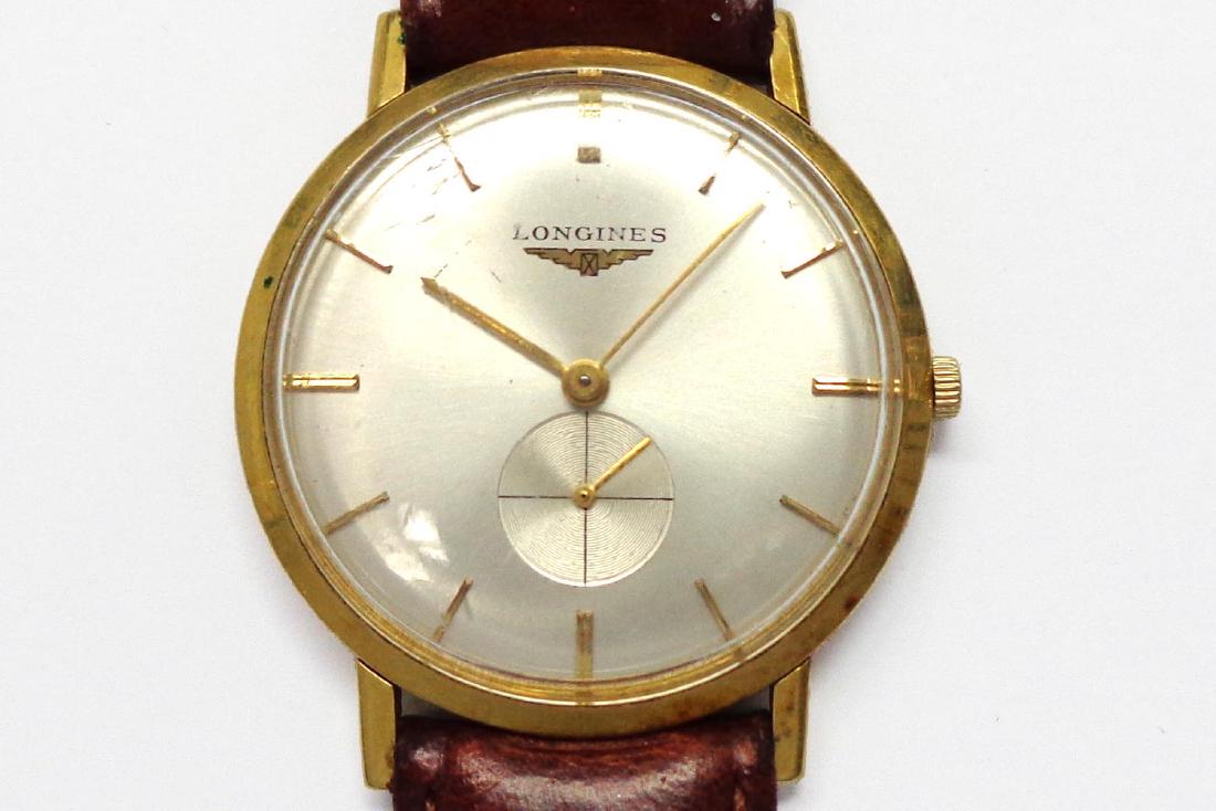 Longines: Man’s vintage 18 karat yellow gold Longines wristwatch manual wind movement on a brown leather bracelet.
