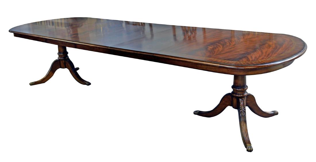 Hepplewhite-style dining table: Fine Hepplewhite-style crossbanded mahogany twin pedestal rectangular dining table, with three extension leaves, vasiform legs and brass capped feet. Approx. 138" long fully extended.