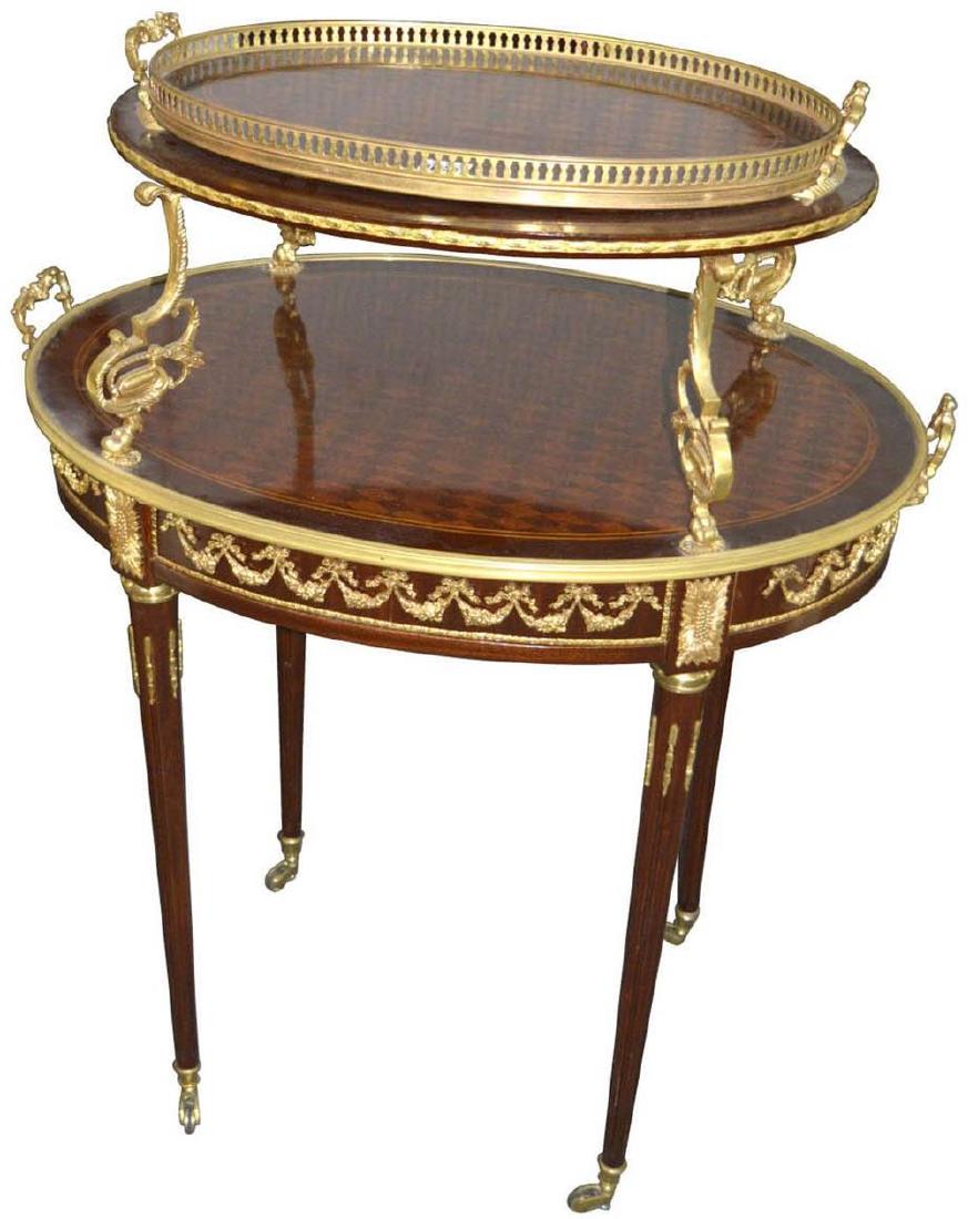 Louis XV-style 2-tier oval serving table: Louis XV-style 2-tier oval serving table, with extensive gilt bronze mounts and removable lift-off tray. Length: 32". Height: 42". Width: 22"