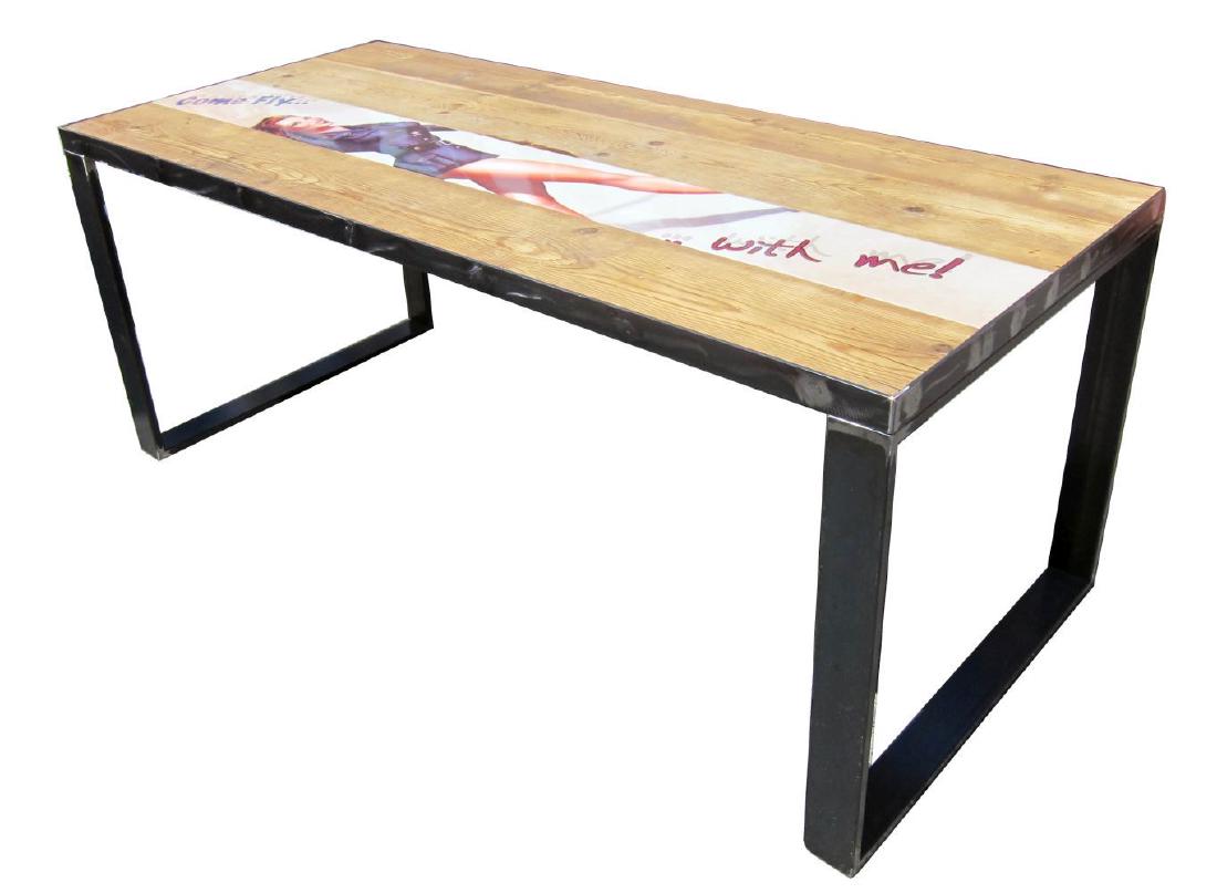 Industrial-style dining table: Superb industrial-style dining table, the recycled wood top decorated with an inset plaque depicting a pin-up woman; on square-form iron legs. Hand-made in Italy. Length: 71". Width: 31". Height: 29".