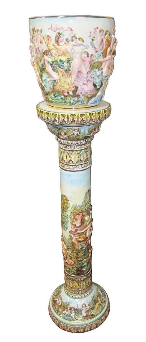 Capodimonte ceramic jardiniÃ¨re on a pedesta: Capodimonte (It.) hand-painted ceramic jardiniÃ¨re on a pedestal, depicting figural scenes and ornate decorations. 44'' tall.