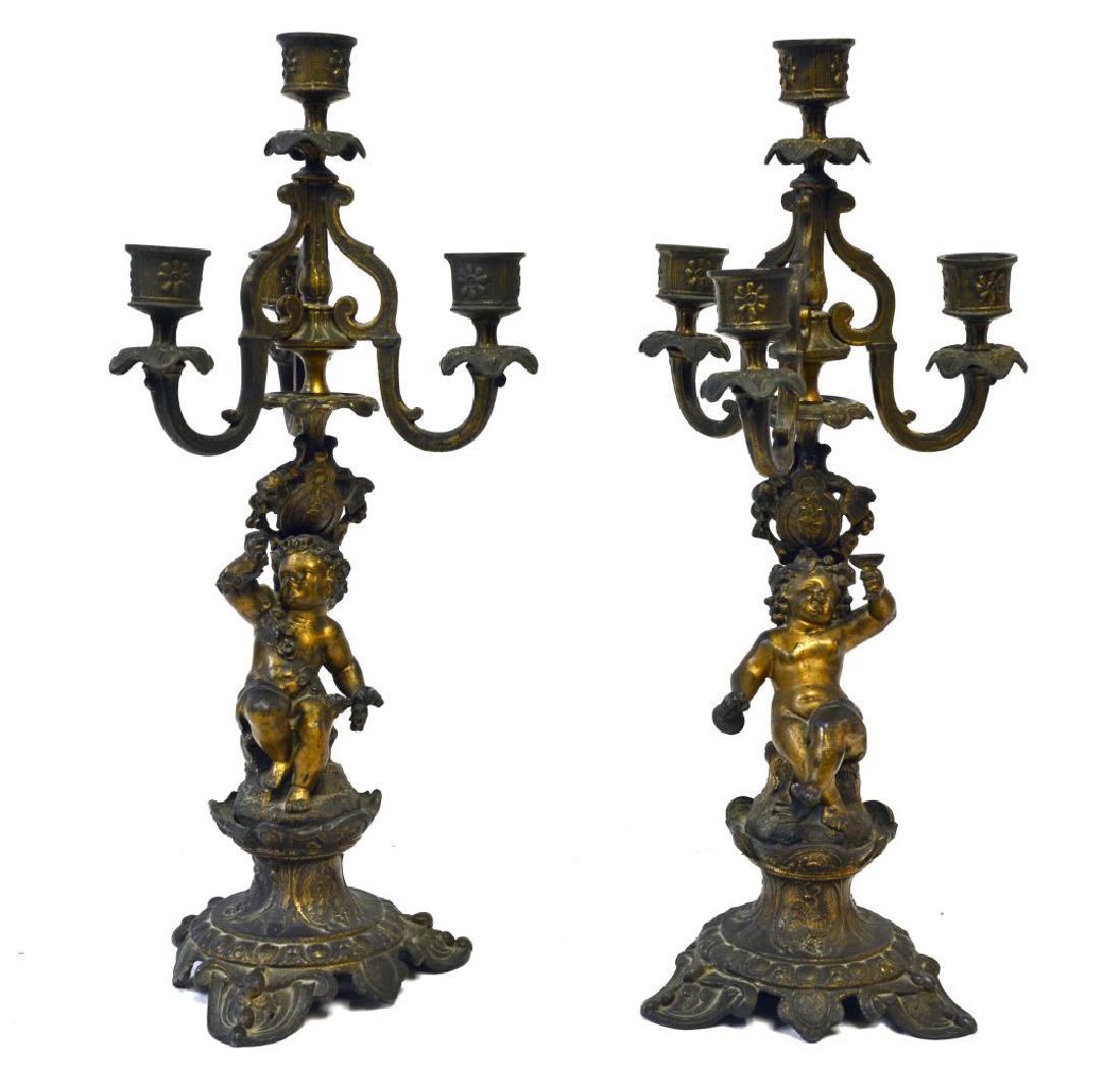 Italian antique bronze candelabras: Pair of Italian antique bronze candelabras with cherubs supports. Height: 15".