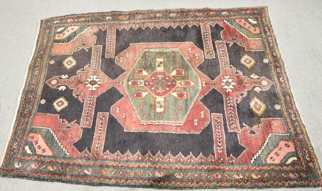 Persian Sirjan rug: Handwoven Persian Sirjan rug, with central lozenge amidst geometric designs on an ebony ground. Approx. 5'3" x 3'10".