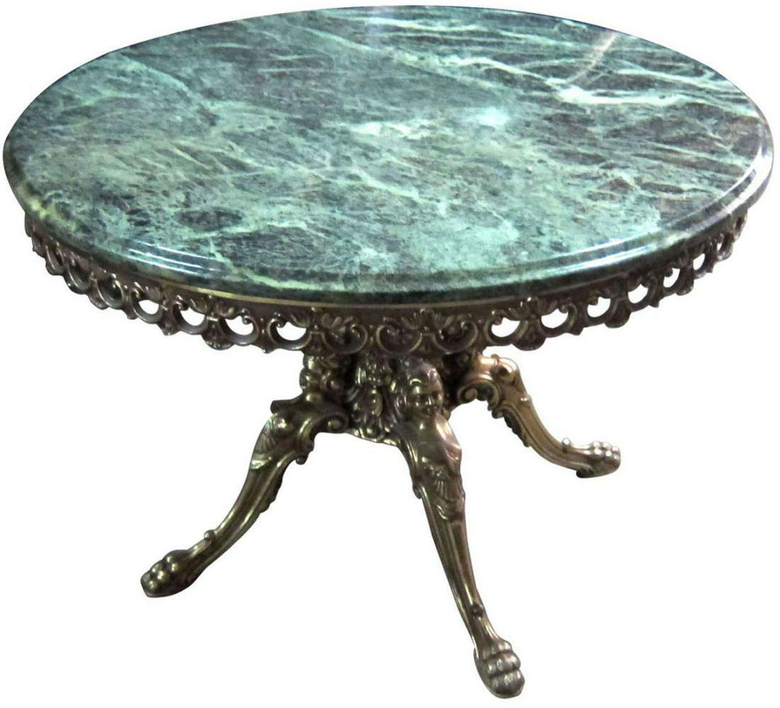 Italian salon table: Italian salon table, the circular green marble top with brass skirt; on a solid brass pedestal base. Diam.: 71cm (28"). Height: 48cm (19").