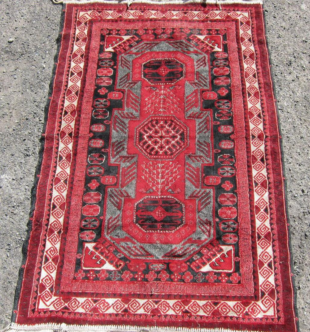 Persian Hamadan rug: Woven Persian Hamadan design rug, with a course of hexagons within a crimson and ebony enclosure with geometric borders. Approx: 3'8" x 2'5".