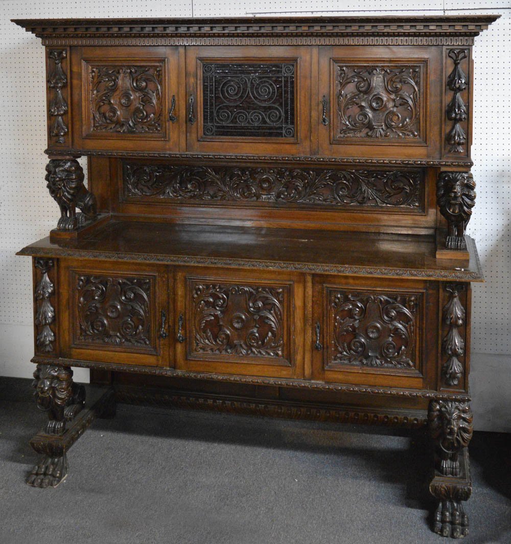 Antique Italian 2-part oak buffet: Antique Italian 2-part oak buffet, ornately hand-carved with foliate designs and lion supports. Fitted with 6 cabinet doors. Height: approx. 92". Width: 79". Depth: 23".