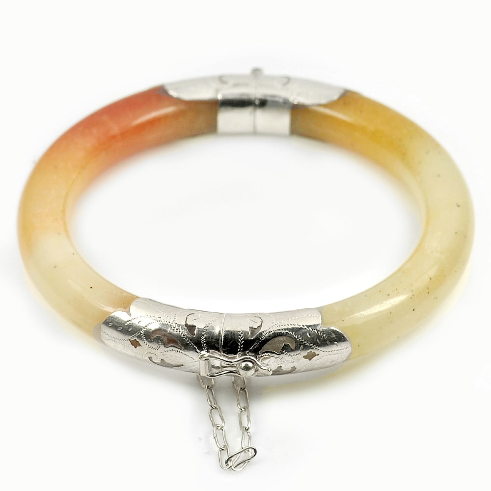 Honey Jade Bangle with Silver 244.59 Ct. Size 80 x 60 x 10 Mm. Natural Gemstone: Product ID: 819814140 Product Name: Natural Jade Weight: 244.59 CT. Size: 80 x 60 x 10 MM. Shape: Round Color: Brown Clarity:Opaque Luster: Good Gems Origin: Thailand Treatment: Unheated Crystal Struc