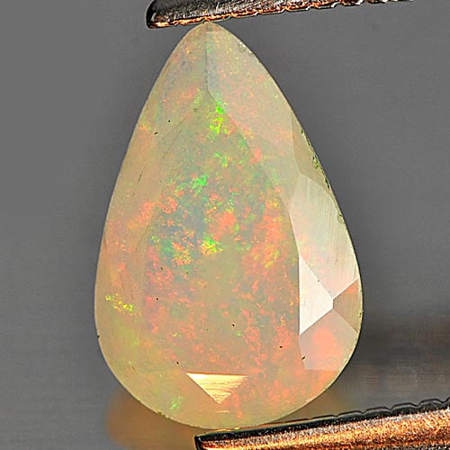 Multi Color Play Of Colour Opal 0.57 Ct. Pear Shape 9.1 x 6 Mm. Natural Unheated Gemstone From: Product ID: 818725905 Product Name: Natural Opal Weight: 0.57 CT. Size: 9.1 x 6 x 3.3 MM. Shape: Pear Color: Multi Color Clarity:Semi - Transparent Luster: Strong Iridescent Gems Origin: Ethiopia Trea