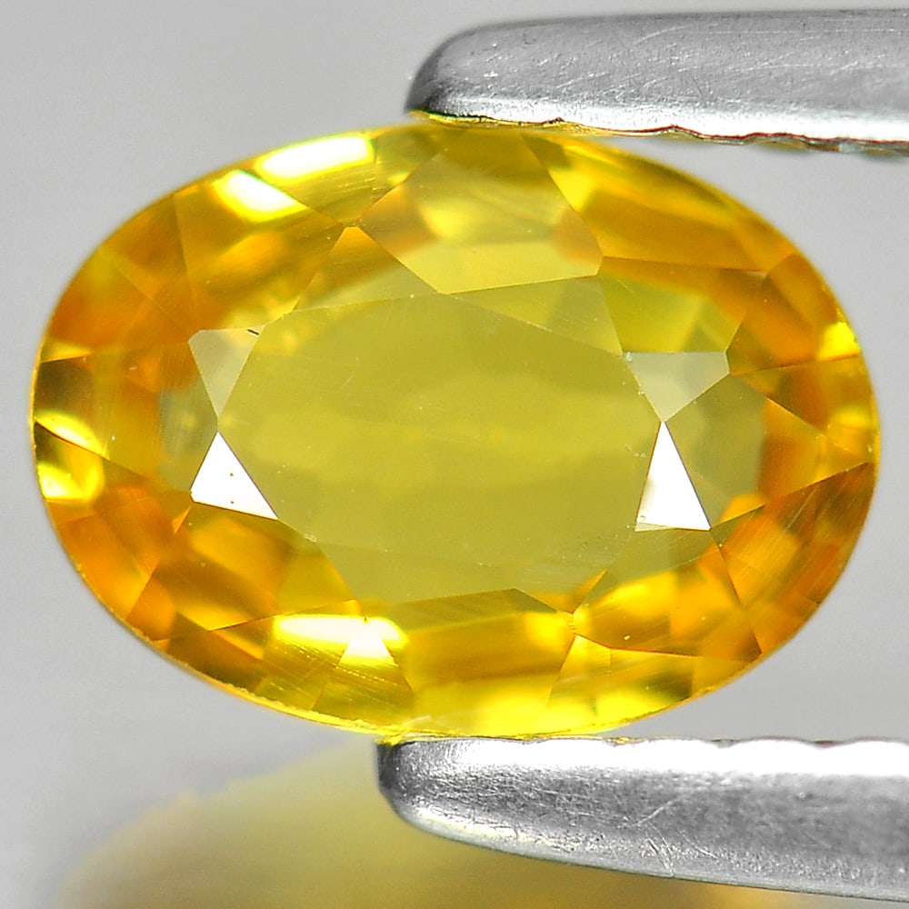 Natural Yellow Sapphire 0.96 Ct. VS Oval Shape 7 x 5.1 Mm. Gemstone From Thailand: Product ID: 806150919 Product Name: Natural Yellow Sapphire Weight: 0.96 CT. Size: 7 x 5.1 x 2.7 MM. Shape: Oval Color: Yellow Clarity:VS Luster: Very Good Gems Origin: Thailand Treatment: Heated Crys