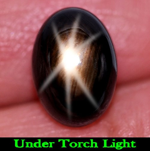 Natural Black Star Sapphire 6 Rays4.90 Ct. Oval Cabochon Shape 10 x 7.3 Mm. Gemstone: Product ID: 806155131 Product Name: Natural Star Sapphire Weight: 4.90 CT. Size: 10 x 7.3 x 5.7 MM. Shape: Oval Cabochon Color: Black Clarity:Opaque Luster: Good 6 Rays Star Gems Origin: Thailand Trea