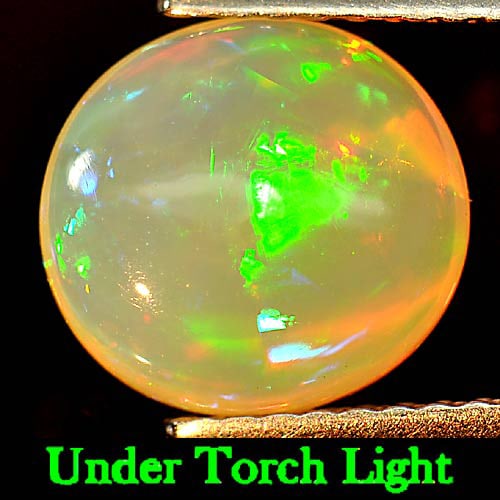 Natural Multi Color Opal Play Of Colour 1.72 Ct. Oval Cabochon Shape 9.3 x 8.6 Mm. Gemstone: Product ID: 818725744 Product Name: Natural Opal Weight: 1.72 CT. Size: 9.3 x 8.6 x 4.5 MM. Shape: Oval Cabochon Color: Multi Color Clarity:Semi - Transparent Luster: Iridescent Gems Origin: Ethiopia 