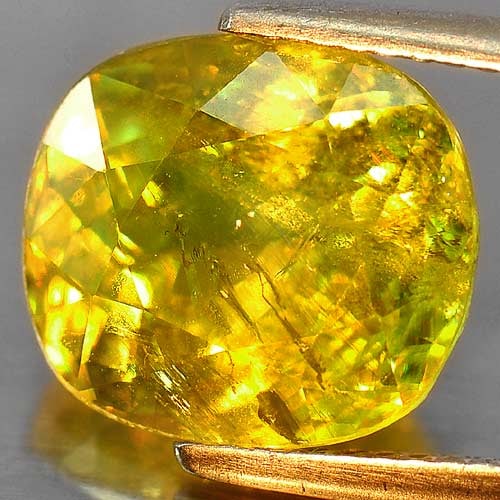 Intense Green Titanium Red Spark Sphene 6.39 Ct. Cushion Shape 11.6 x 10.3 Mm. Natural Gemstone From: Product ID: 806503348 Product Name: Natural Sphene Weight: 6.39 CT. Size: 11.6 x 10.3 x 6.5 MM. Shape: Cushion Color: Intense Green With Red Spark Clarity:SI Luster: Adamantine Gems Origin: Mardagasca