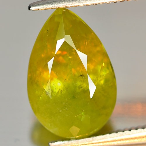 Intense Green Titanium Red Spark Sphene 4.00 Ct. Pear Shape 11.9 x 8 Mm. Natural Gemstone From: Product ID: 806504569 Product Name: Natural Sphene Weight: 4.00 CT. Size: 11.9 x 8 x 6 MM. Shape: Pear Color: Intense Green With Red Spark Clarity:VSI - SI Luster: Adamantine Gems Origin: Madagascar T