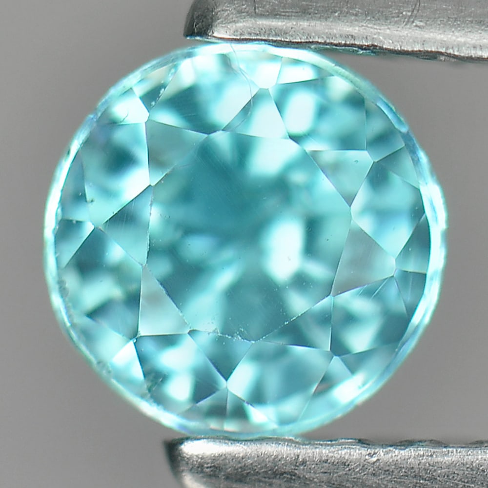 Blue Zircon 0.86 Ct. VVS Round Shape 5 Mm. Natural Gemstone From Cambodia: Product ID: 807730780 Product Name: Natural Zircon Weight: 0.86 CT. Size: 5 x 5 x 3.7 MM. Shape: Round Color: Blue Clarity:VVS Luster: Good Gems Origin: Cambodia Treatment: Heated Crystal Structure: T