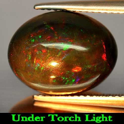 Natural Fire Red Black Opal 6.59 Ct. Play Of Color Rainbow Oval Cabochon Shape 15 x 11.3 Mm.: Product ID: 818725515 Product Name: Natural Opal Weight: 6.59 CT. Size: 15 x 11.3 x 8.5 MM. Shape: Oval Cabochon Color: Rainbow Fire Red Black Clarity:Opaque Luster: Iridescent Gems Origin: Ethiopia T