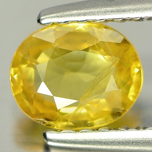 Natural Yellow Sapphire 0.76 Ct. Oval Shape 6.1 x 5 Mm. Gemstone From Thailand: Product ID: 806125020 Product Name: Natural Yellow Sapphire Weight: 0.76 CT. Size: 6.1 x 5 x 2.6 MM. Shape: Oval Color: Yellow Clarity:SI Luster: Good Gems Origin: Bangkaja, Thailand Treatment: Heated
