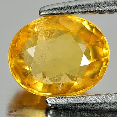 Natural Yellow Sapphire 1.19 Ct. Oval Shape 6.7 x 5.4 Mm. Gemstone From Thailand: Product ID: 806140015 Product Name: Natural Orange Sapphire Weight: 1.19 CT. Size: 6.7 x 5.4 x 3.3 MM. Shape: Oval Color: Orange Clarity:SI Luster: Good Gems Origin: Thailand Treatment: Heated Crystal