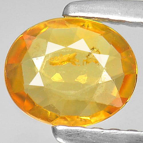 Natural Yellow Sapphire 0.77 Ct. Oval Shape 6.5 x 5.4 Mm. Gemstone From Thailand: Product ID: 806140033 Product Name: Natural Orange Sapphire Weight: 0.77 CT. Size: 6.5 x 5.4 x 2.2 MM. Shape: Oval Color: Orange Clarity:SI Luster: Good Gems Origin: Thailand Treatment: Heated Crystal