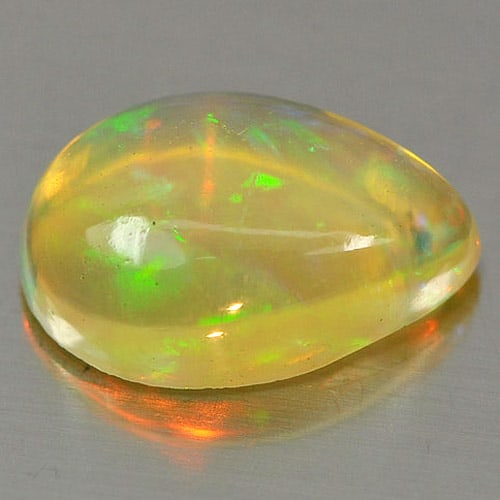 Natural Multi Color Play Of Colour Opal 0.92 Ct. Pear Cabochon Shape 9 x 6 Mm. Gemstone From: Product ID: 818726332 Product Name: Natural Opal Weight: 0.92 CT. Size: 9 x 6.1 x 3.6 MM. Shape: Pear Cabochon Color: Multi Color Clarity:Semi - Transparent Luster: Iridescent Gems Origin: Ethiopia Tr