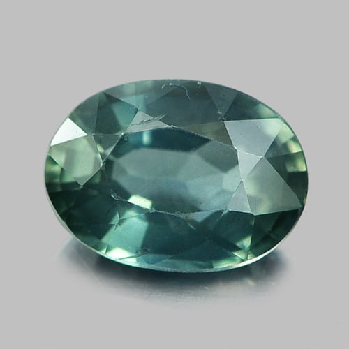 Natural Bluish Green Sapphire 0.74 Ct. Oval Shape 6.4 x 4.6 Mm. Gemstone From Thailand: Product ID: 806154625 Product Name: Natural Green Sapphire Weight: 0.74 CT. Size: 6.4 x 4.6 x 2.9 MM. Shape: Oval Color: Bluish Green Clarity:VSI Luster: Good Gems Origin: Thailand Treatment: Heated C