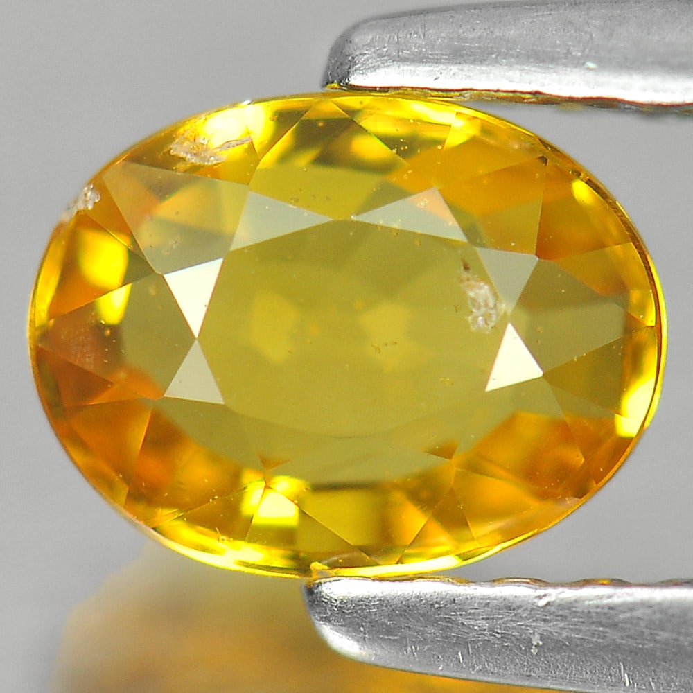 Natural Yellow Sapphire 0.94 Ct. Oval Shape 6.5 x 5 Mm. Gemstone From Thailand: Product ID: 806139927 Product Name: Natural Yellow Sapphire Weight: 0.94 CT. Size: 6.5 x 5 x 2.9 MM. Shape: Oval Color: Yellow Clarity:SI1 Luster: Good Gems Origin: Thailand Treatment: Heated Crystal 