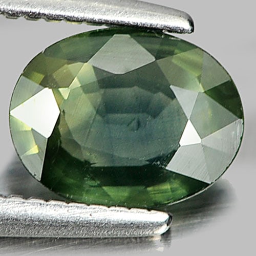 Natural Green Sapphire 0.82 Ct. Oval Shape 6.9 x 5.4 Mm. Gemstone From Thailand: Product ID: 806154684 Product Name: Natural Green Sapphire Weight: 0.82 CT. Size: 6.9 x 5.4 x 2.4 MM. Shape: Oval Color: Green Clarity:VSI Luster: Good Gems Origin: Thailand Treatment: Heated Crystal 