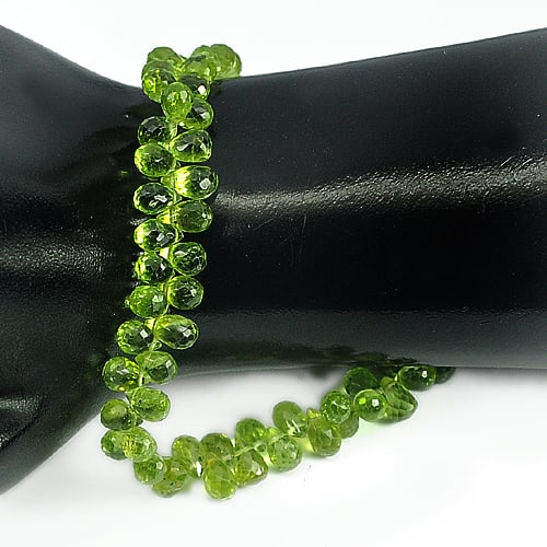 Natural Green Peridot Beads 90.05 Ct. 6.9 x 4.5 Mm. Briolette Shape Gemstone Length 9 Inch: Product ID: 805306811 Product Name: Natural Peridot Weight: 90.05 CT. Size: 9 Inch. / 6.9 x 4.5 MM. Shape: Briolette Color: Green Clarity:VVS Luster: Good Gems Origin: Thailand Treatment: Unheated Cry