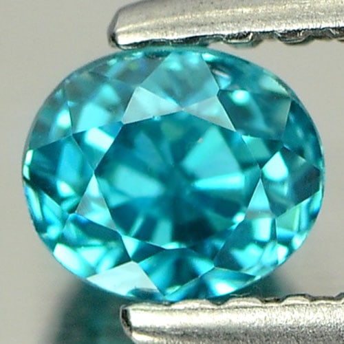 Natural Blue Zircon 0.78 Ct. Clean Oval Shape 4.9 x 4.2 Mm. Gemstone From Cambodia: Product ID: 807712176 / Product Name: Natural Zircon / Weight: 0.78 CT. / Size: 4.9 x 4.2 x 3.9 MM. / Shape: Oval / Color: Blue / Clarity:IF / Luster: Very Good / Gems Origin: Cambodia / Treatment: He