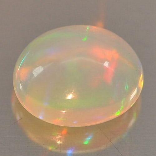 Play Of Colour Multi Color Opal 0.80 Ct. Oval Cabochon Shape 7.1 x 5.8 Mm. Natural Gemstone From: Product ID: 818726120 Product Name: Natural Opal Weight: 0.80 CT. Size: 7.1 x 5.8 x 4.3 MM. Shape: Oval Cabochon Color: Multi Color Clarity:Opaque Luster: Iridescent Gems Origin: Ethiopia Treatment: U