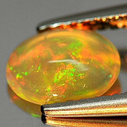 Natural Play Of Colour Multi Color Opal 0.58 Ct. Oval Cabochon Shape 7.6 x 5.9 Mm. Gemstone From: Product ID: 818726013 Product Name: Natural Opal Weight: 0.58 CT. Size: 7.6 x 5.9 x 3.1 MM. Shape: Oval Cabochon Color: Multi Color Clarity:Opaque Luster: Iridescent Gems Origin: Ethiopia Treatment: U