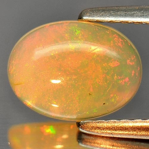 Natural Multi Color Opal 0.89 Ct. Oval Cabochon Shape 9 x 6.8 Mm. Unheated Gemstone: Product ID: 818726262 Product Name: Natural Opal Weight: 0.89 CT. Size: 9 x 6.8 x 3 MM. Shape: Oval Cabochon Color: Multi Color Clarity:Semi - Transparent Luster: Iridescent Gems Origin: Ethiopia Trea